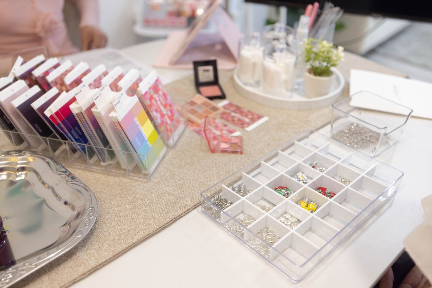 A blush compact and eyeshadow palette on the color-matching table at Soori Studio