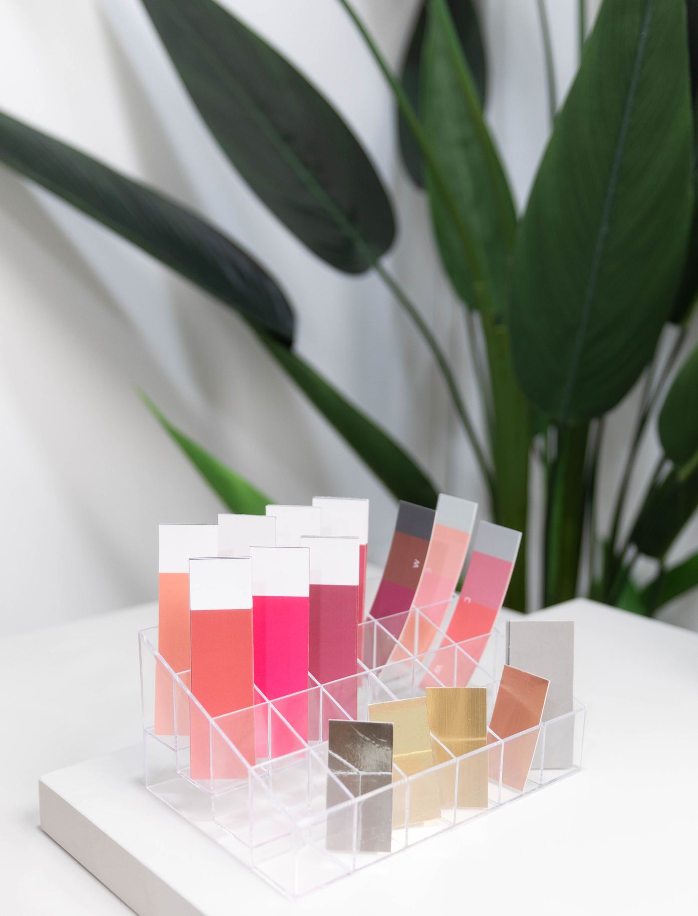 A tray of lipstick color swatches used to test shades against skin tone at Soori Studio