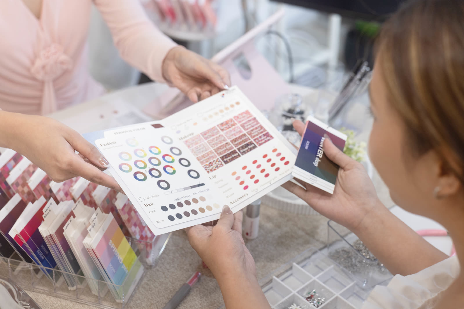 A client receiving her personal color summary card with makeup, lip, and hair recommendations
