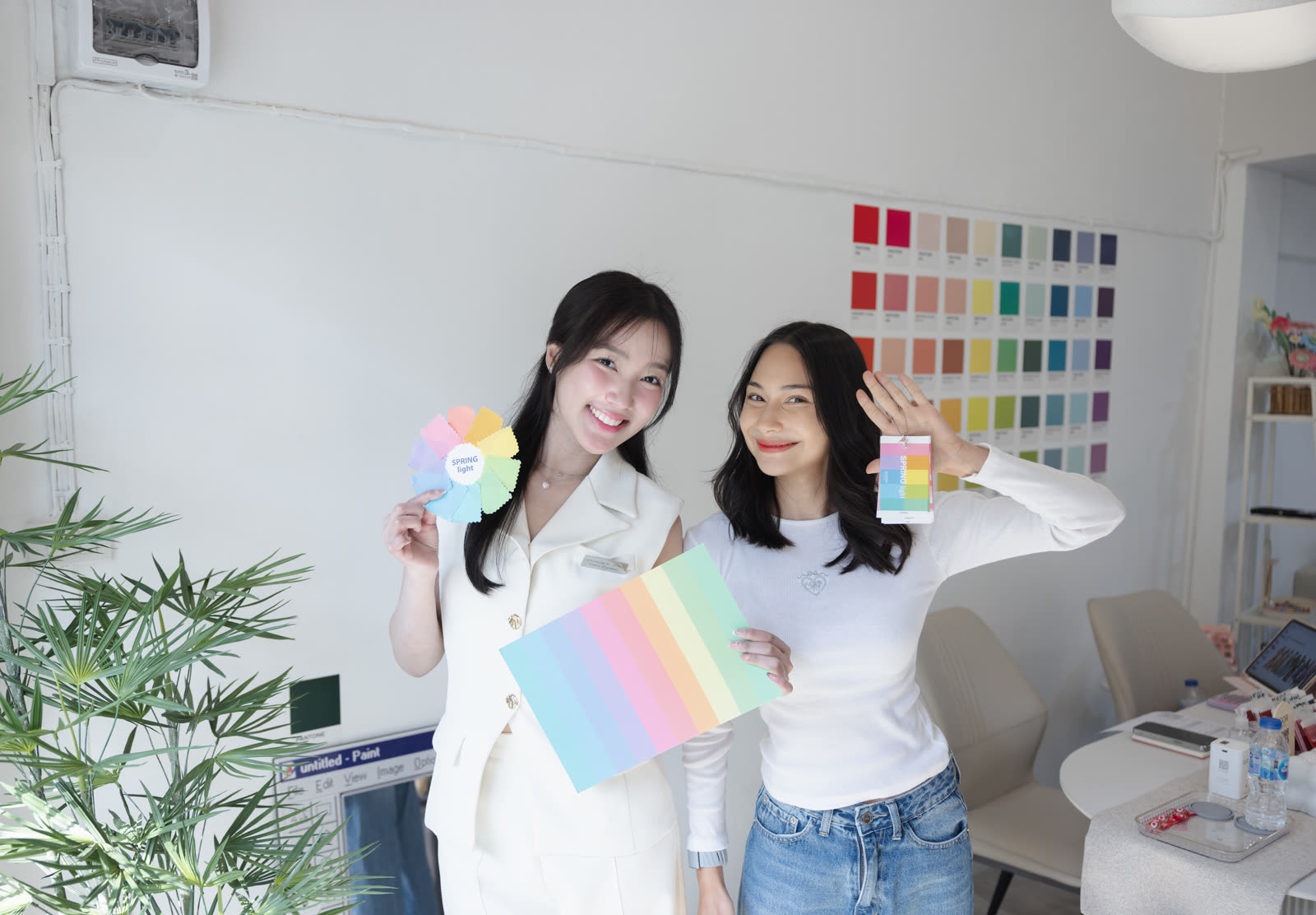 Two smiling clients holding their Spring Light palette results at Soori Studio