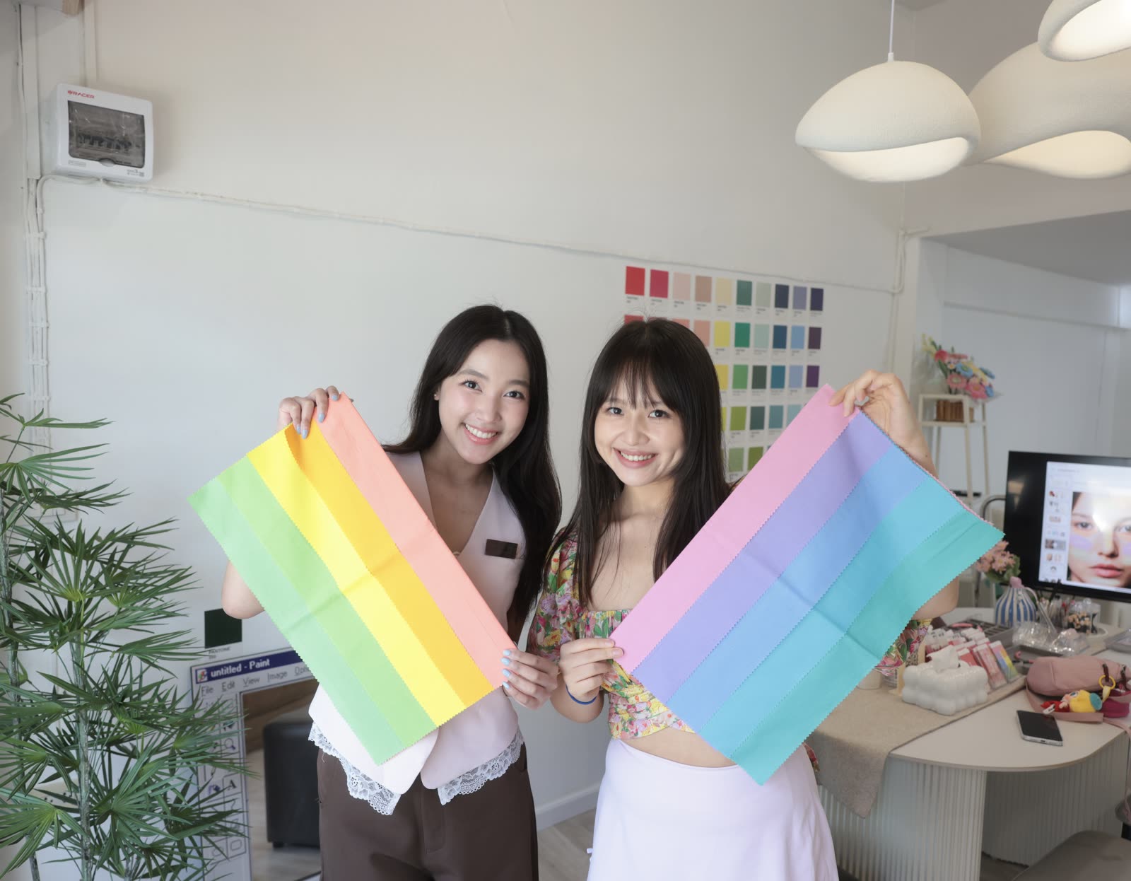 Analyst and client comparing warm and cool fabric drapes during a session
