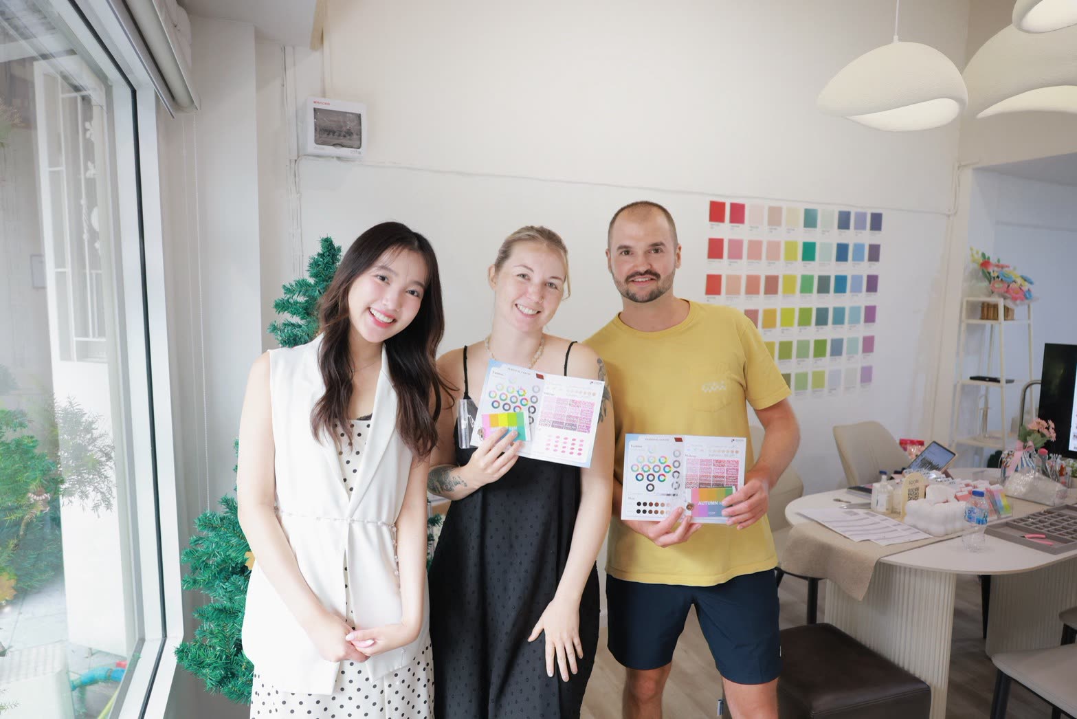 International clients showing their Autumn color analysis results at Soori Studio Bangkok